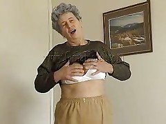Sexy granny Rosa takes her clothing off and reveals that saggy breasts of hers. That babe squeezes them for greater amount enjoyment and lays down on the bed. The horny old lady spreads her legs and fingers her cunt a little. That babe has a sex tool and is willing to play with it. Wanna see her sucking and sticking it in her pussy?